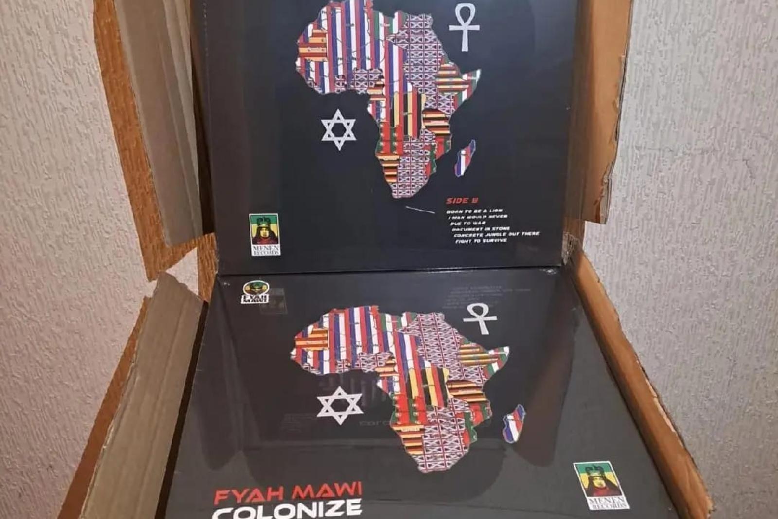 Fyah Mawi music releases and packaging arranged in an open box, view 4.