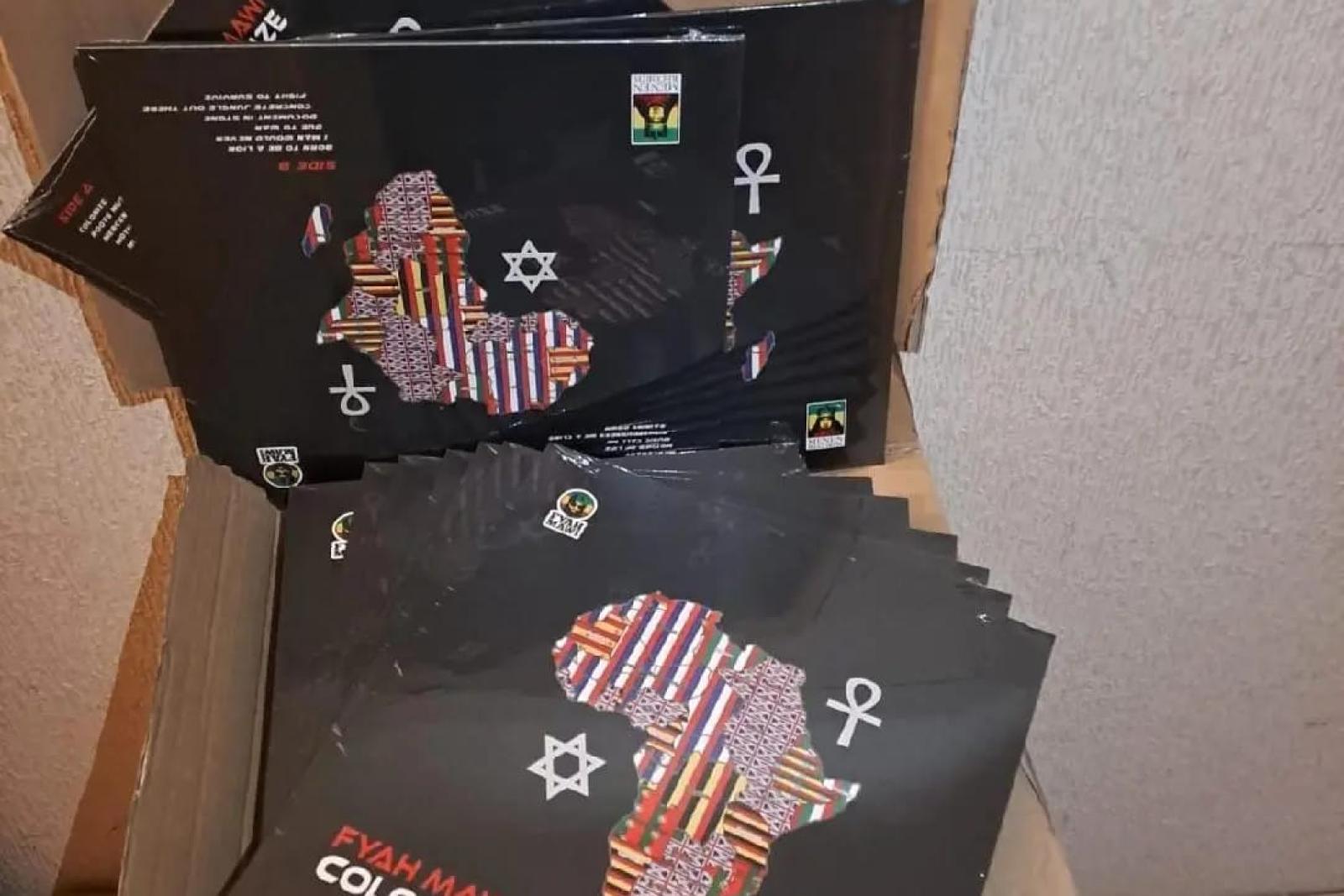 Fyah Mawi music releases and packaging arranged in an open box, view 5.