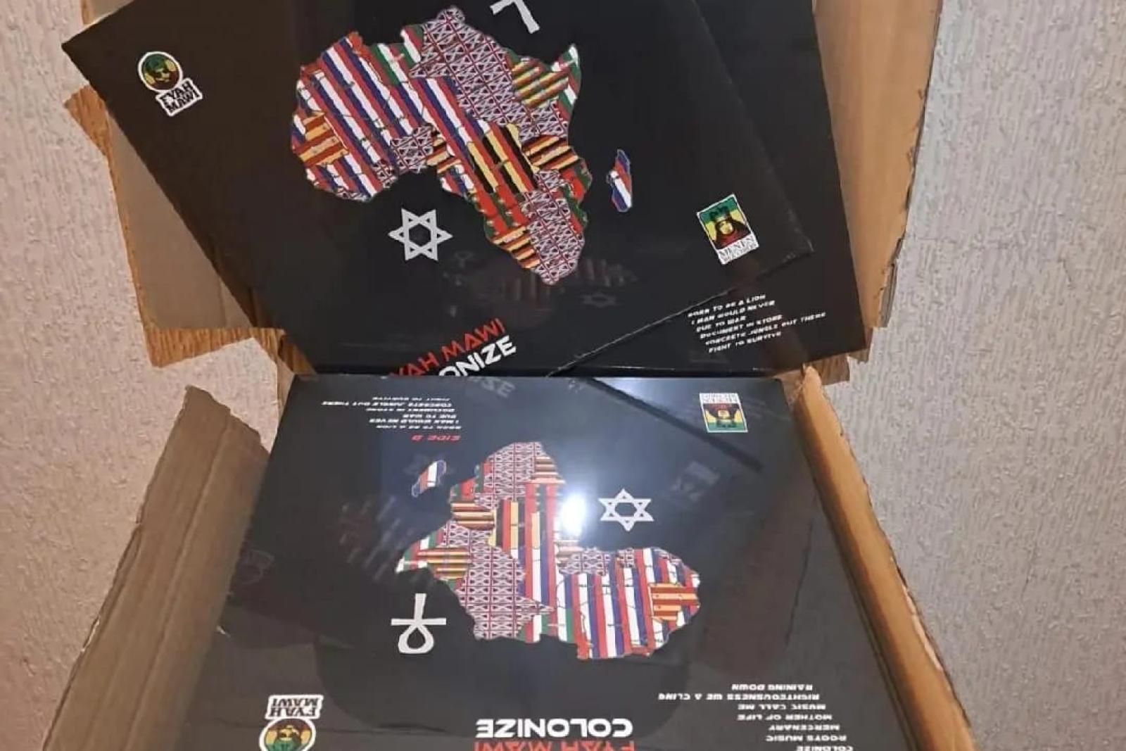 Fyah Mawi music releases and packaging arranged in an open box, view 6.