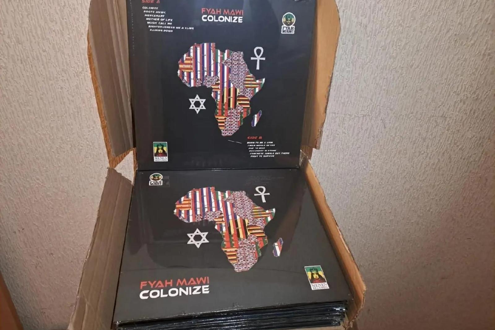 Fyah Mawi music releases and packaging arranged in an open box, view 7.