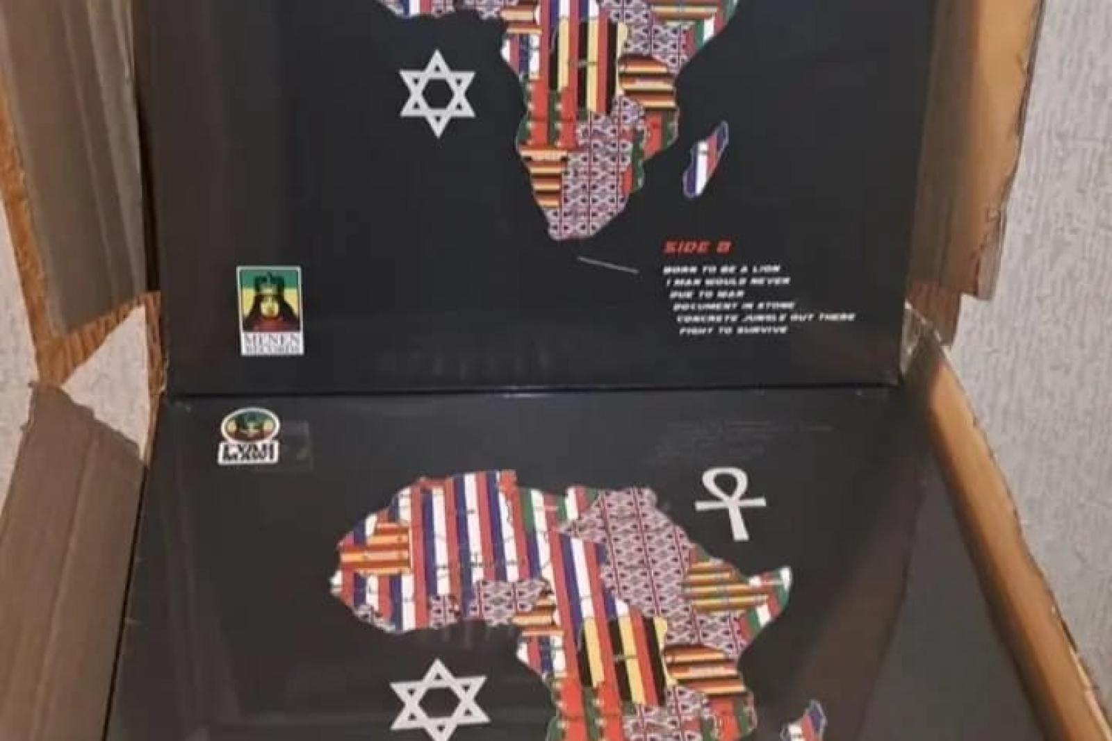 Fyah Mawi music releases and packaging arranged in an open box, view 8.